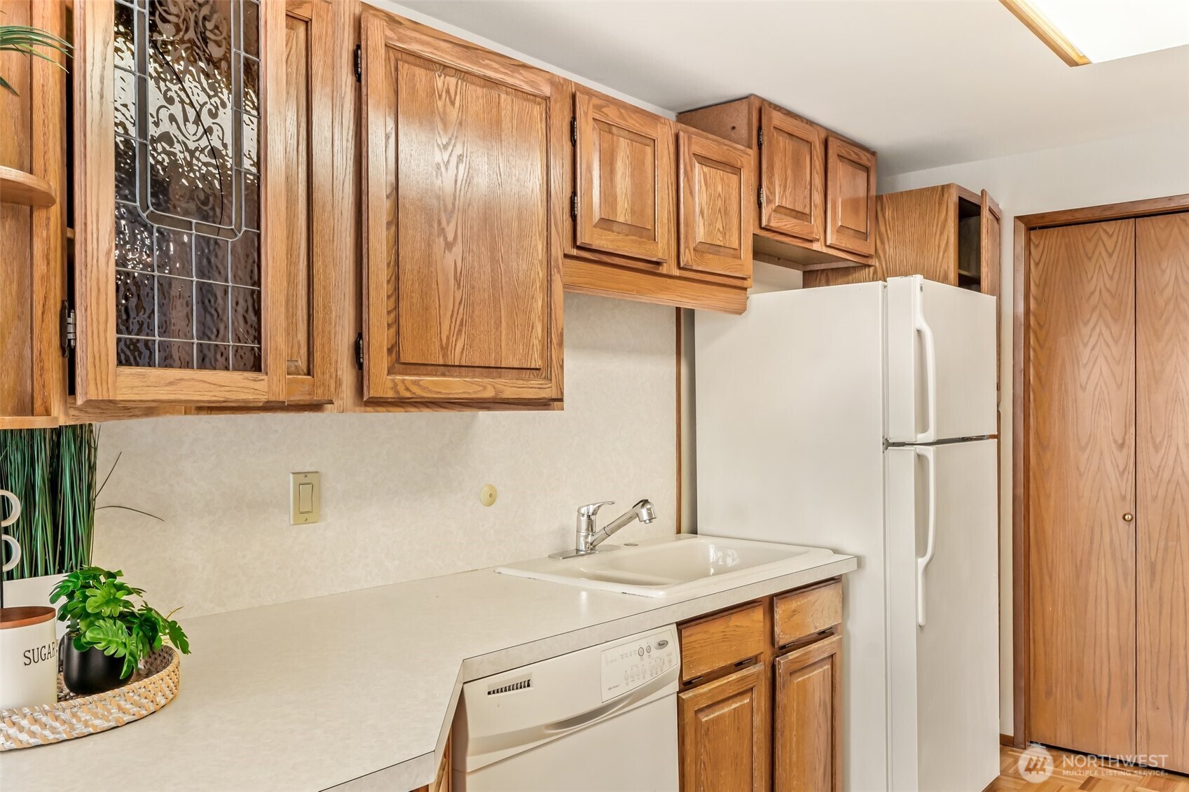 722 North 85th Street, Unit 41 Seattle, WA 98103 - Photo 9 of 24 a kitchen with a sink a refrigerator and cabinets
