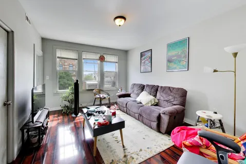 a living room with furniture and a floor to ceiling window