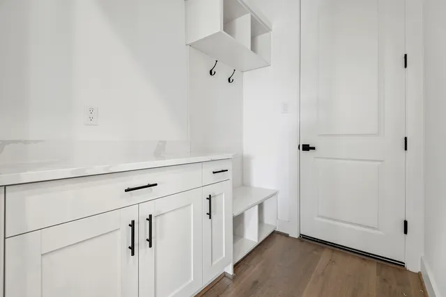 a view of a kitchen with white cabinets