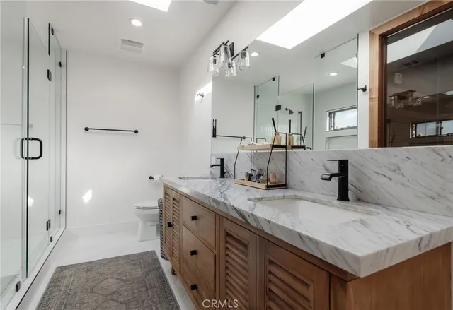 a bathroom with a sink vanity and mirror