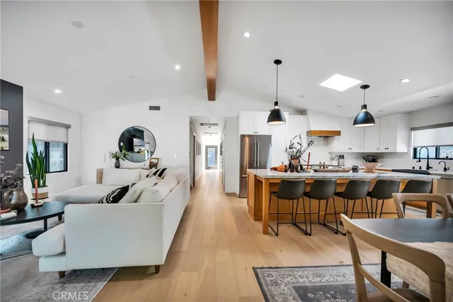 a kitchen with stainless steel appliances granite countertop a sink a stove and a refrigerator