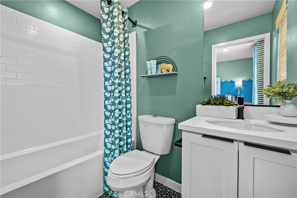 1936 West Sycamore Drive Compton, CA 90220 - Photo 11 of 19 a bathroom with a granite countertop toilet a sink and a mirror