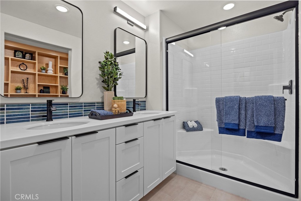 1936 West Sycamore Drive Compton, CA 90220 - Photo 13 of 19 a bathroom with a double vanity sink a mirror and a