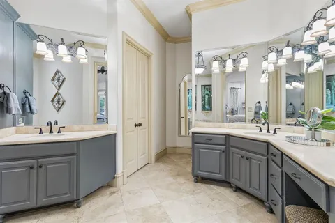 a spacious bathroom with a double vanity sink mirror and double