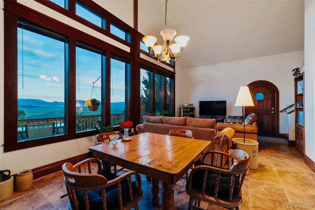 a living room with patio furniture and a large window