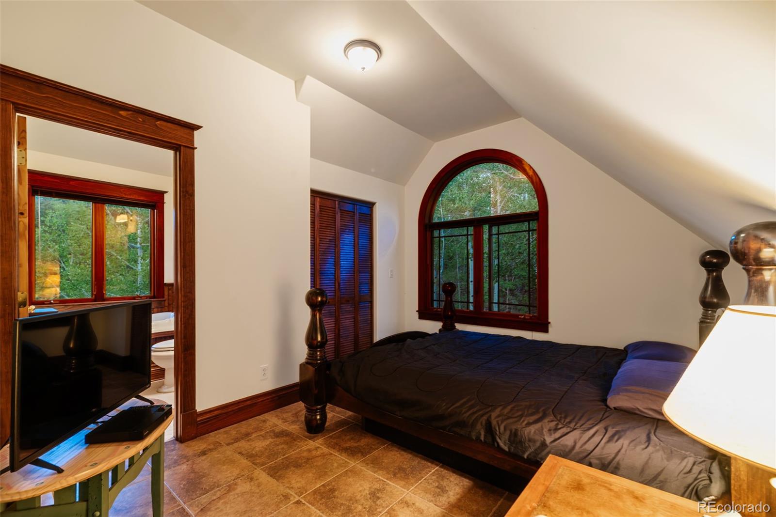 1023 Raven Way Como, CO 80432 - Photo 18 of 40 a living room with a bed and a flat screen tv