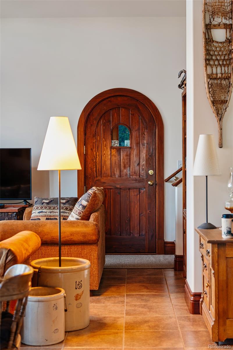 1023 Raven Way Como, CO 80432 - Photo 20 of 40 a living room with furniture a flat screen tv and a fireplace