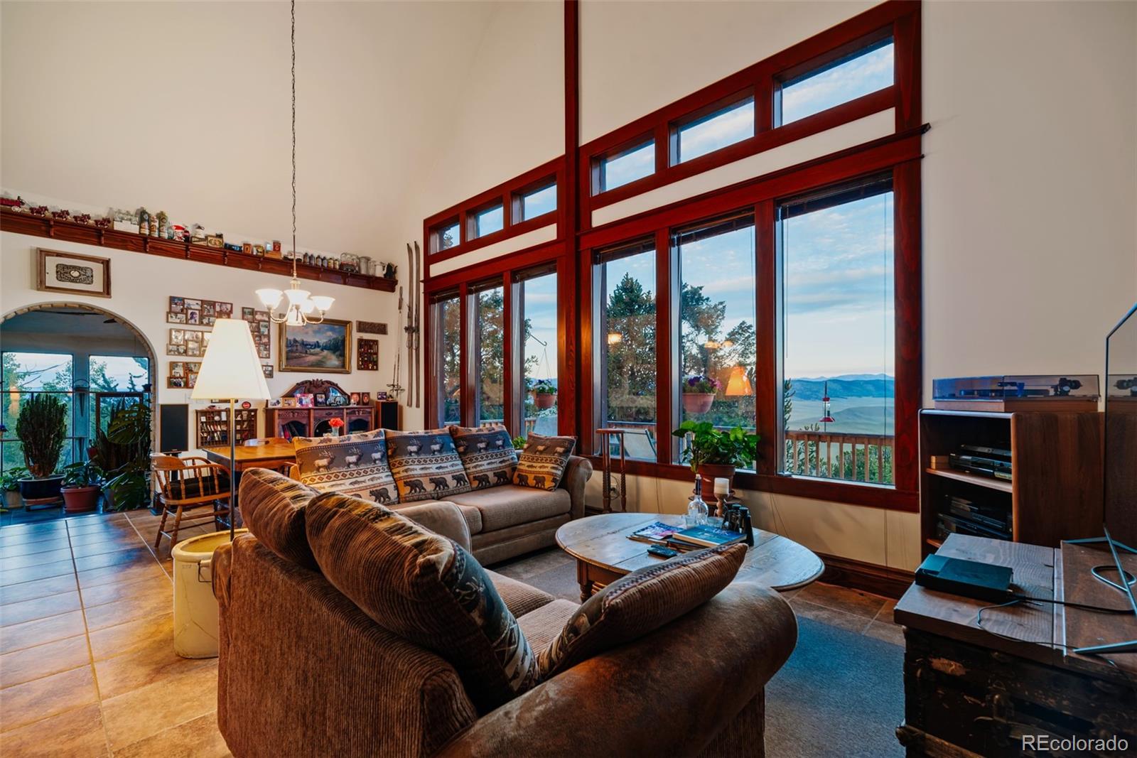 1023 Raven Way Como, CO 80432 - Photo 2 of 40 a living room with furniture a flat screen tv and a floor to ceiling window