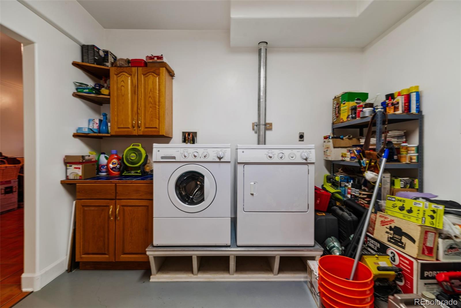 1023 Raven Way Como, CO 80432 - Photo 25 of 40 a utility room with dryer washer and shoe rack