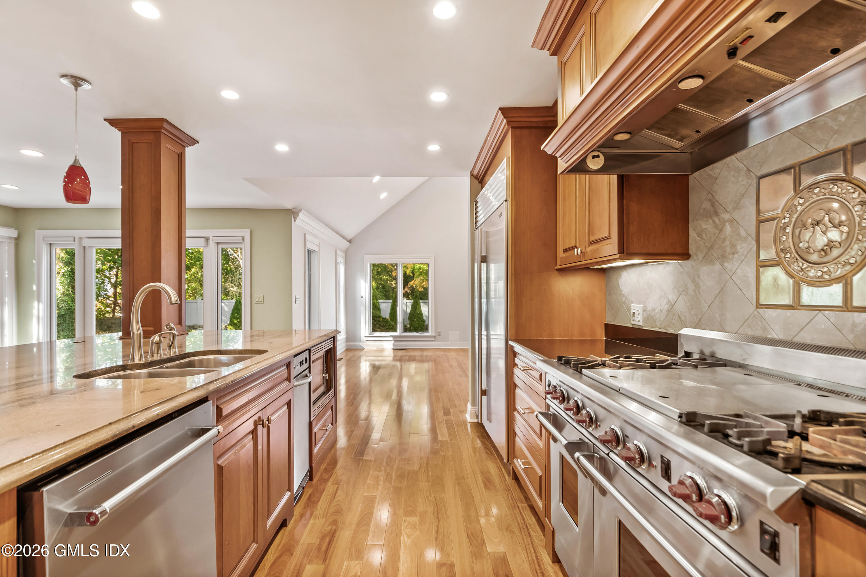 145 R Shore Road Old Greenwich, CT 06870 - Photo 14 of 41 a kitchen with stainless steel appliances a stove a sink a refrigerator and wooden cabinets