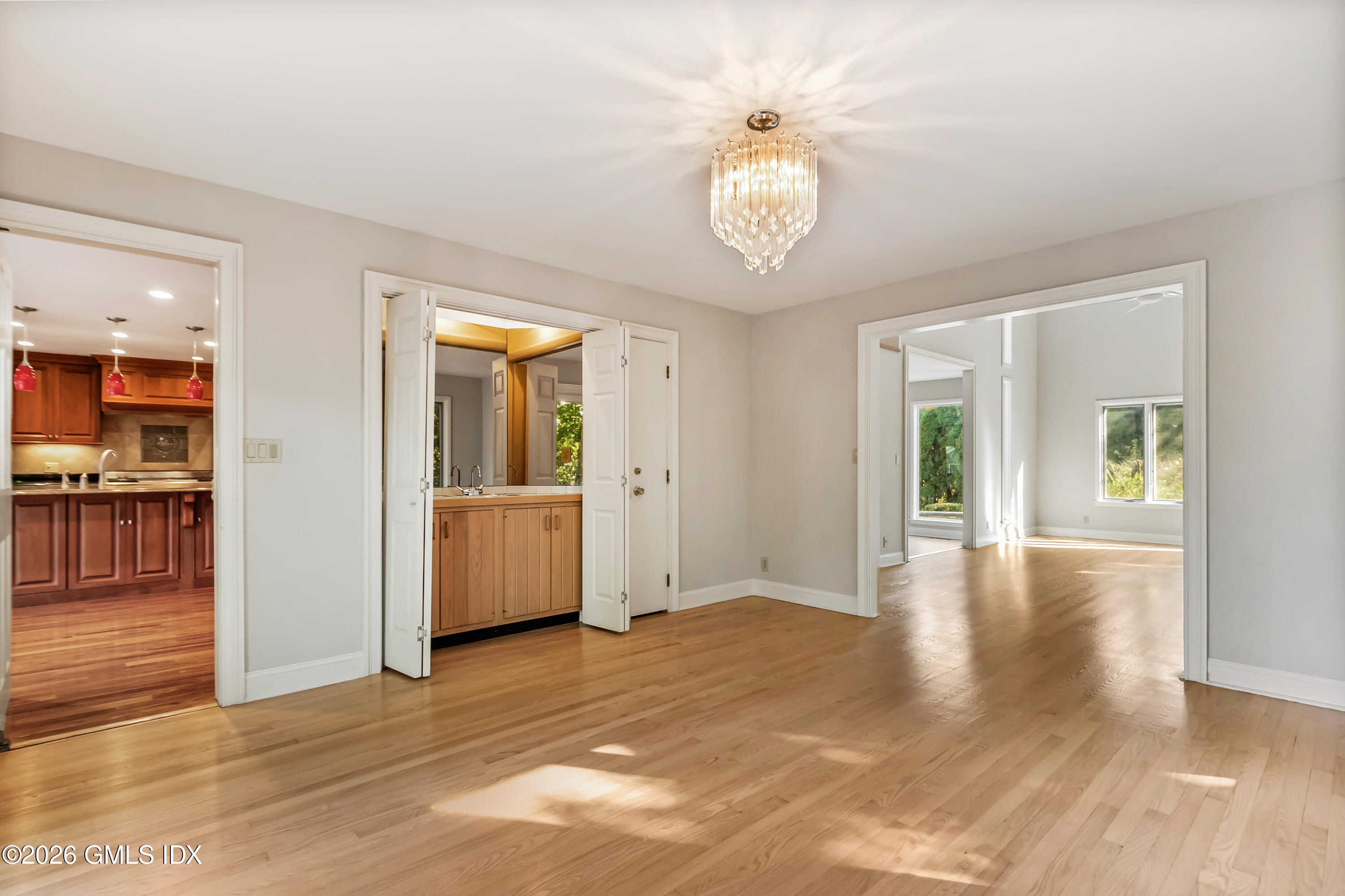 145 R Shore Road Old Greenwich, CT 06870 - Photo 18 of 41 an empty room with wooden floor and entrance