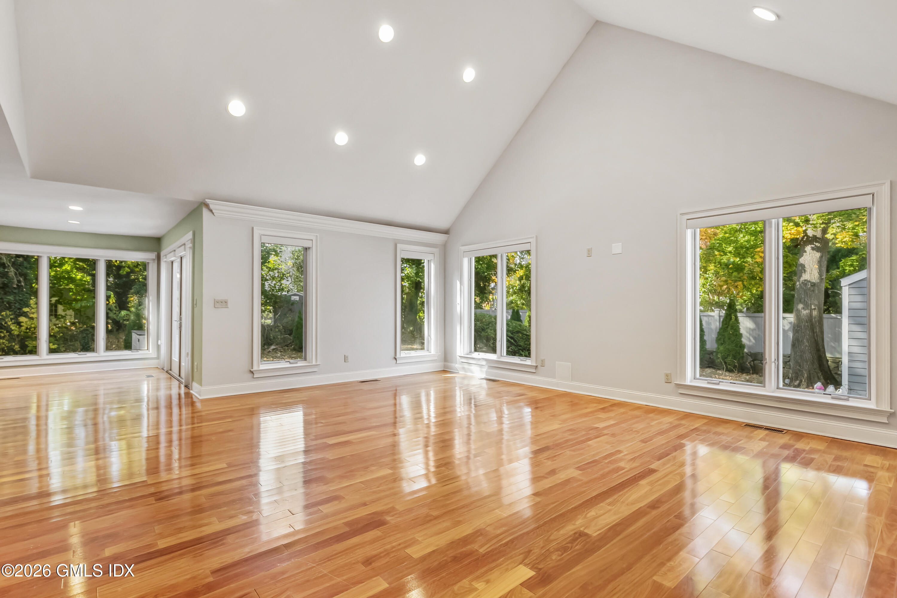 145 R Shore Road Old Greenwich, CT 06870 - Photo 20 of 41 a view of an empty room with wooden floor and a window