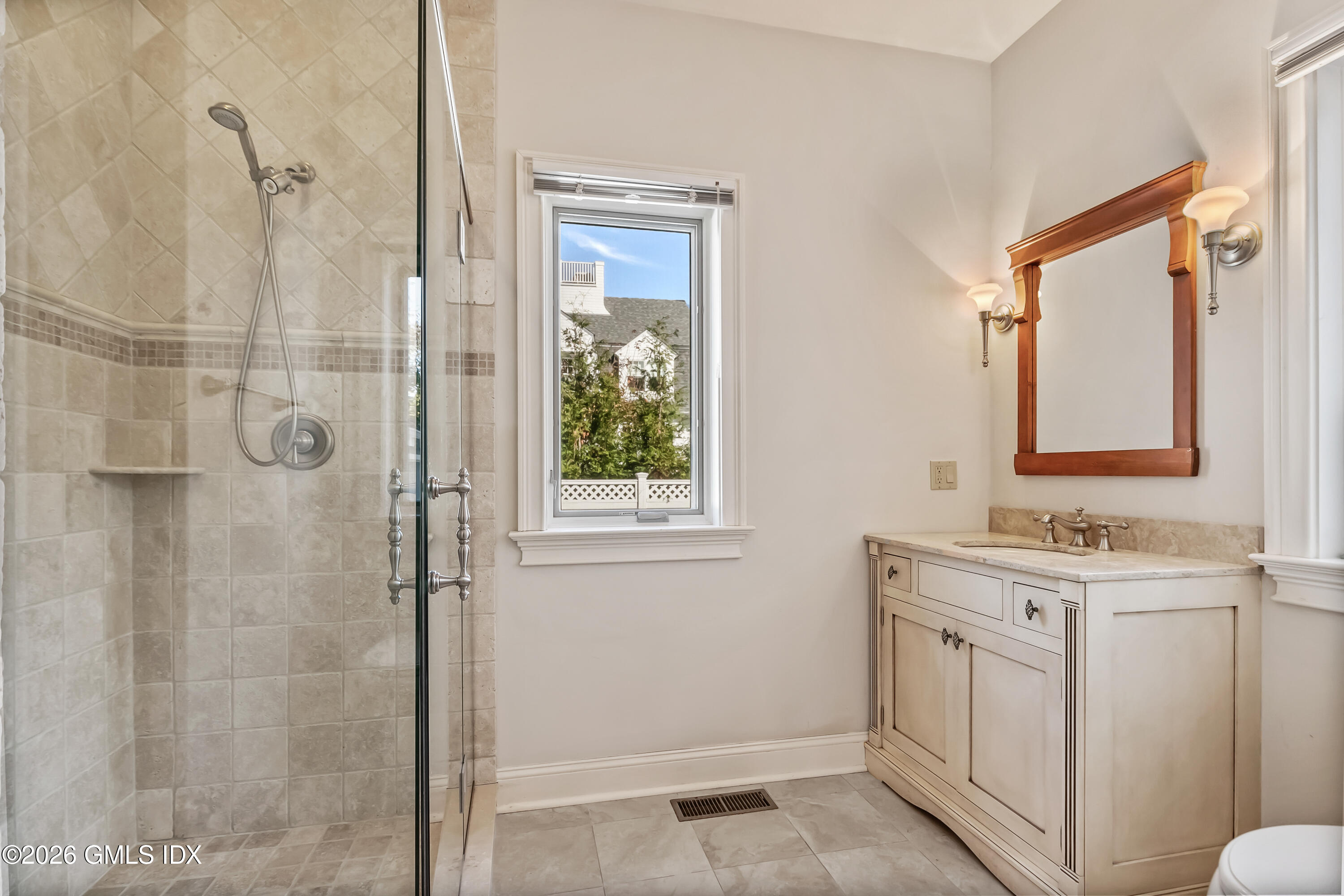 145 R Shore Road Old Greenwich, CT 06870 - Photo 23 of 41 a bathroom with a double vanity sink a mirror and shower