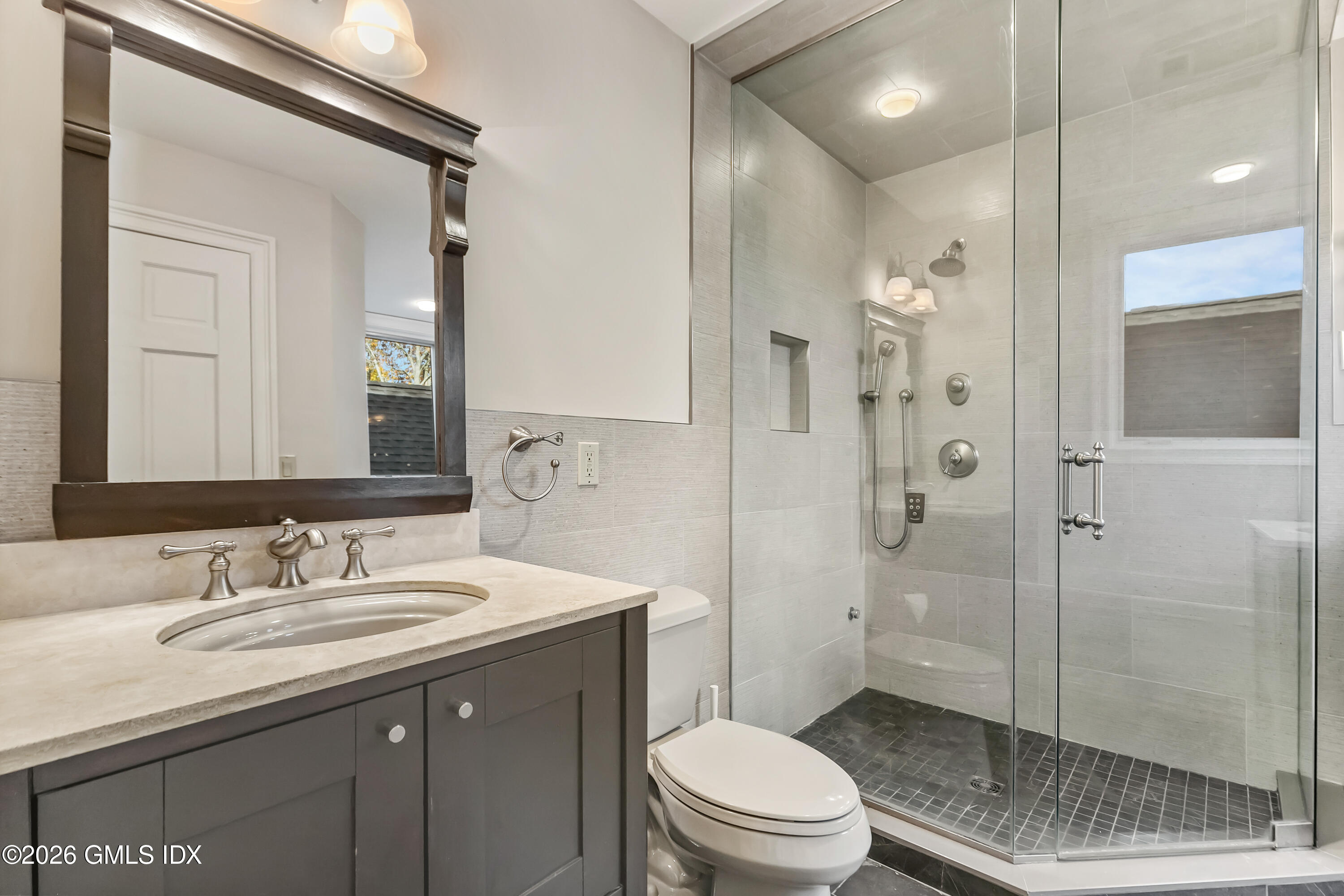 145 R Shore Road Old Greenwich, CT 06870 - Photo 28 of 41 a bathroom with a granite countertop sink a toilet and shower