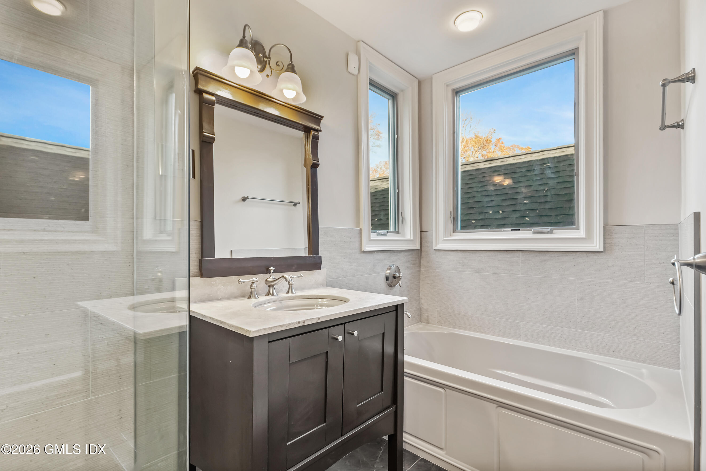 145 R Shore Road Old Greenwich, CT 06870 - Photo 29 of 41 a bathroom with a sink and a mirror