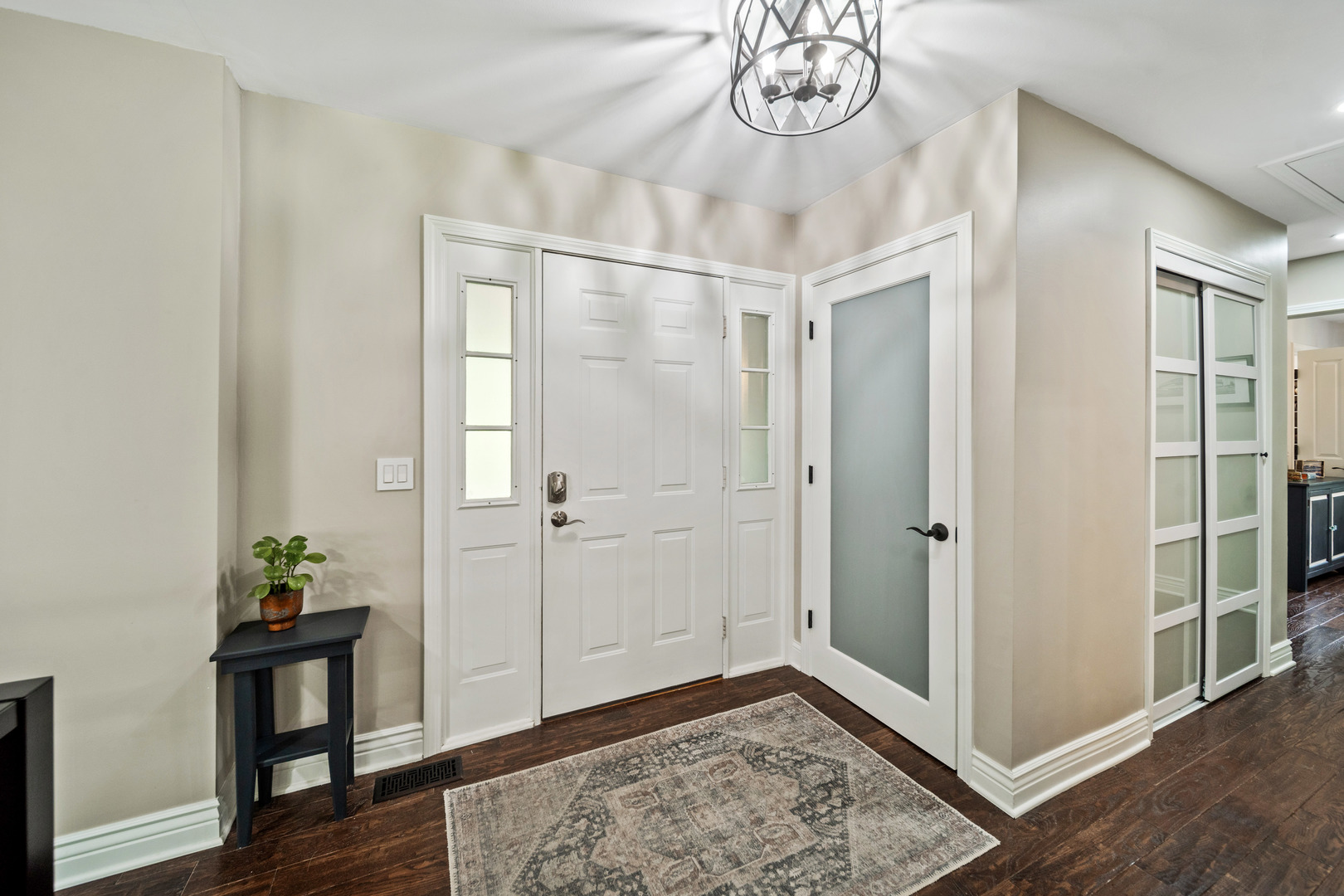 28W140 Mack Road Wheaton, IL 60189 - Photo 17 of 48 a view of a hallway with wooden floor and a chandelier