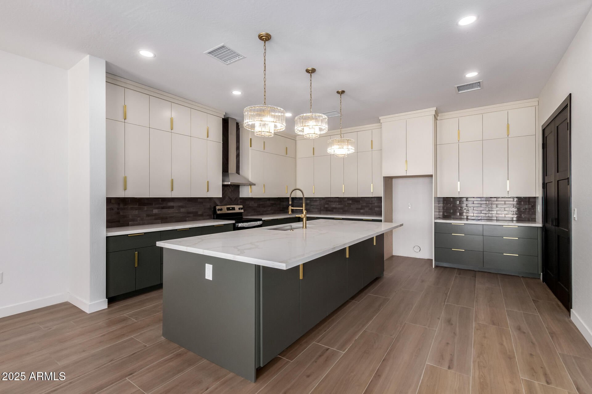 25117 West McArthur Road Wittmann, AZ 85361 - Photo 11 of 43 a large kitchen with stainless steel appliances a large counter top a stove a sink dishwasher and a refrigerator