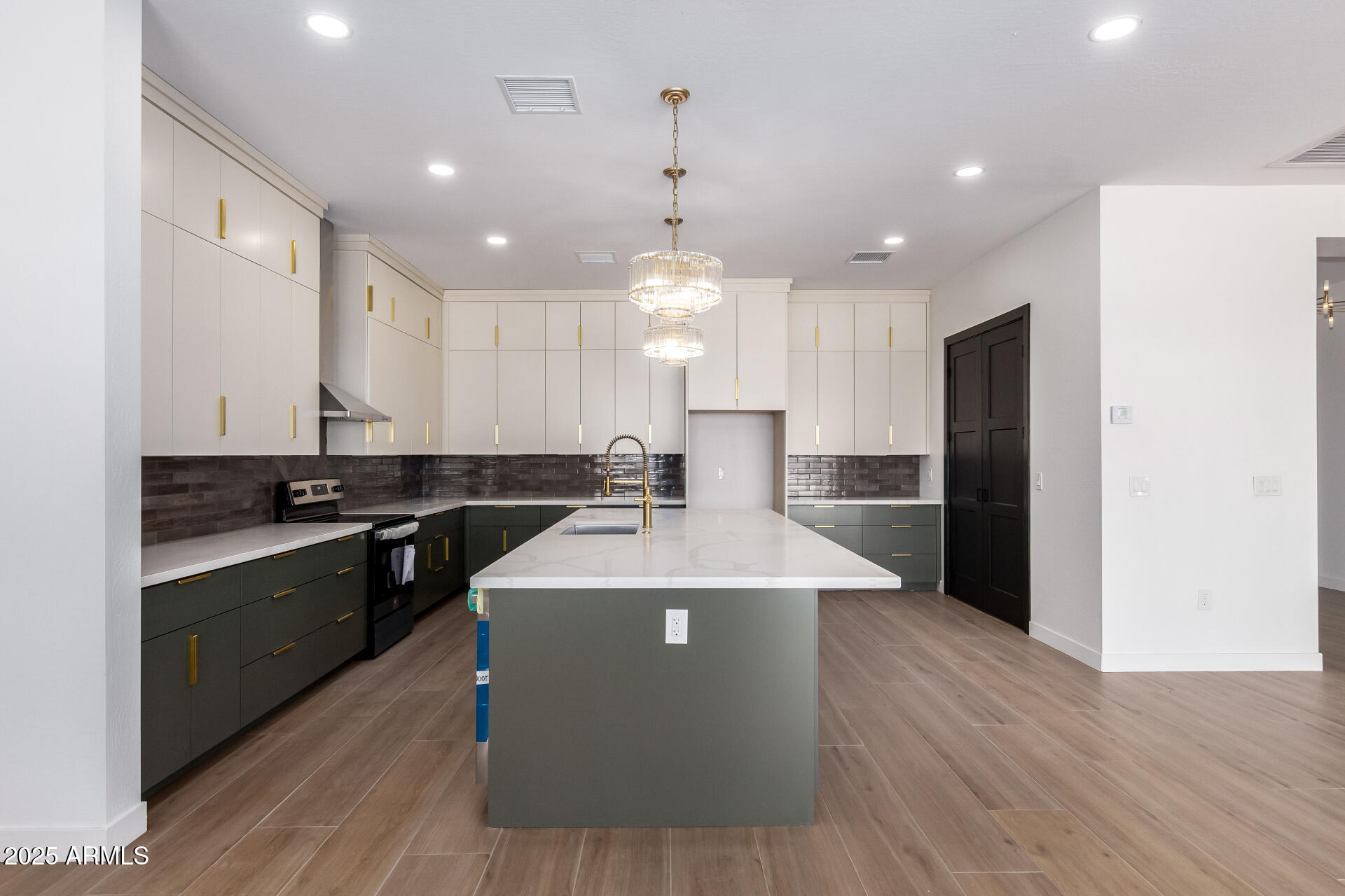25117 West McArthur Road Wittmann, AZ 85361 - Photo 15 of 43 a large kitchen with stainless steel appliances kitchen island granite countertop a large counter top and wooden floors