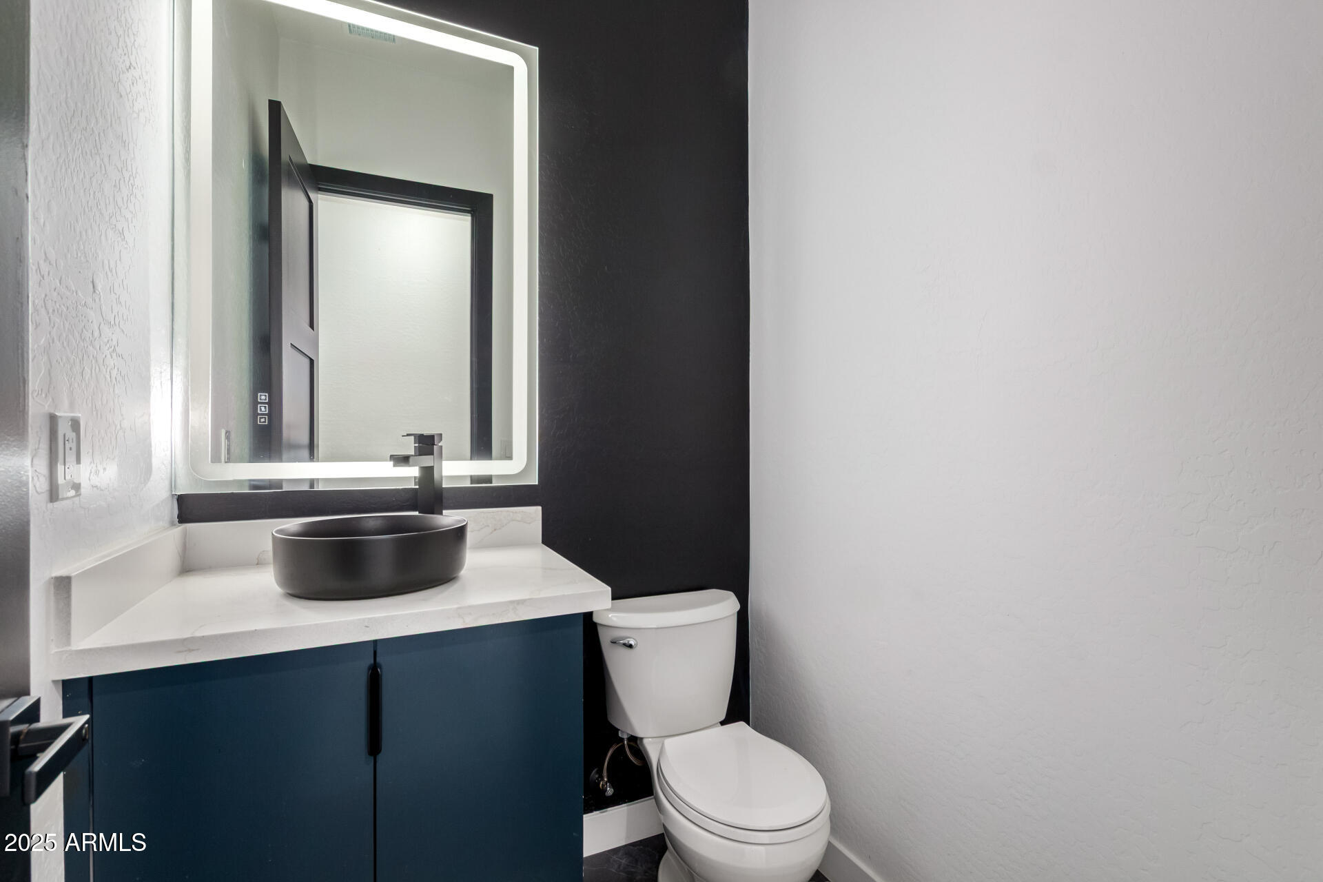 25117 West McArthur Road Wittmann, AZ 85361 - Photo 17 of 43 a bathroom with a sink toilet and mirror