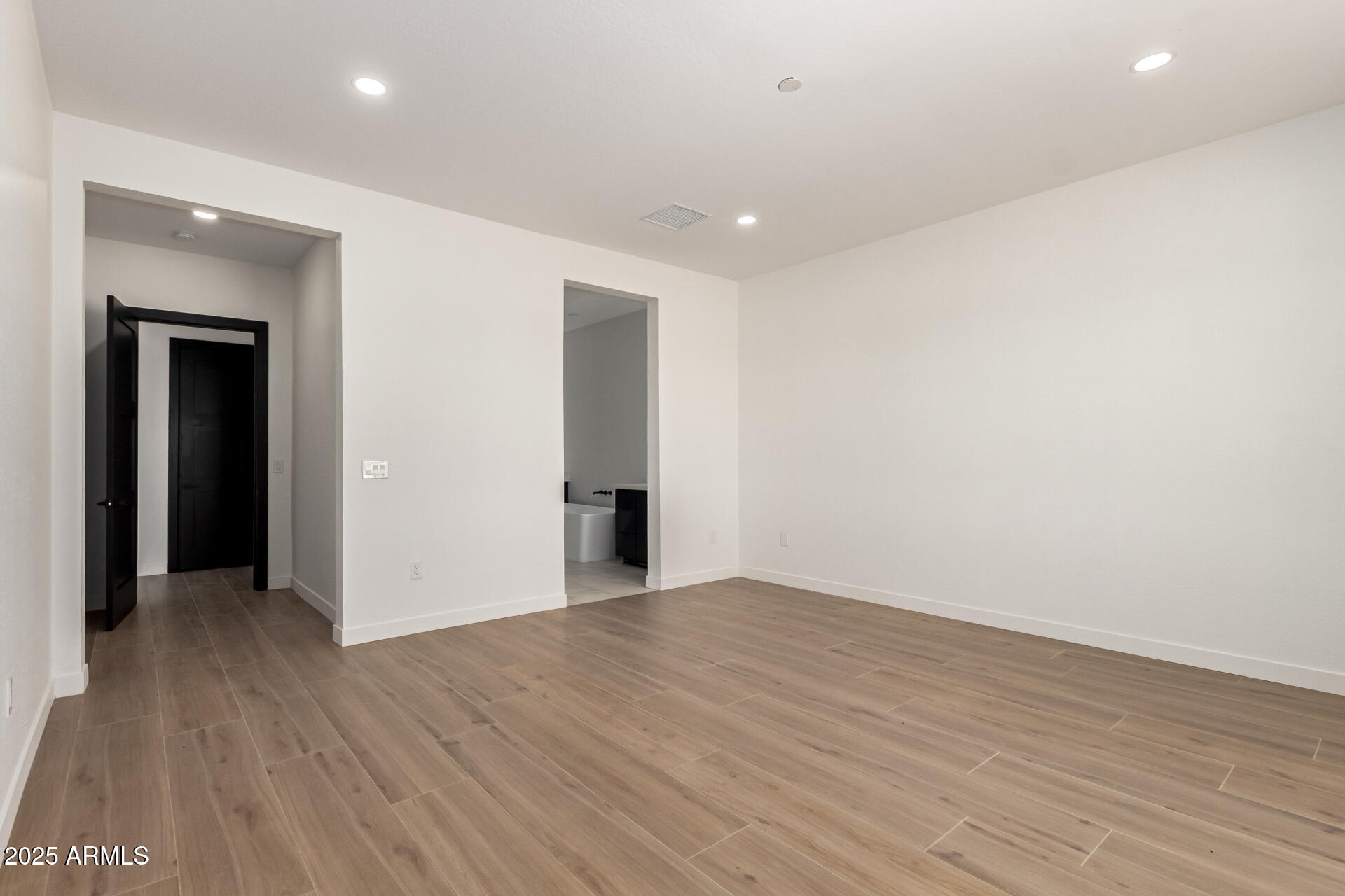 25117 West McArthur Road Wittmann, AZ 85361 - Photo 19 of 43 a view of an empty room with wooden floor
