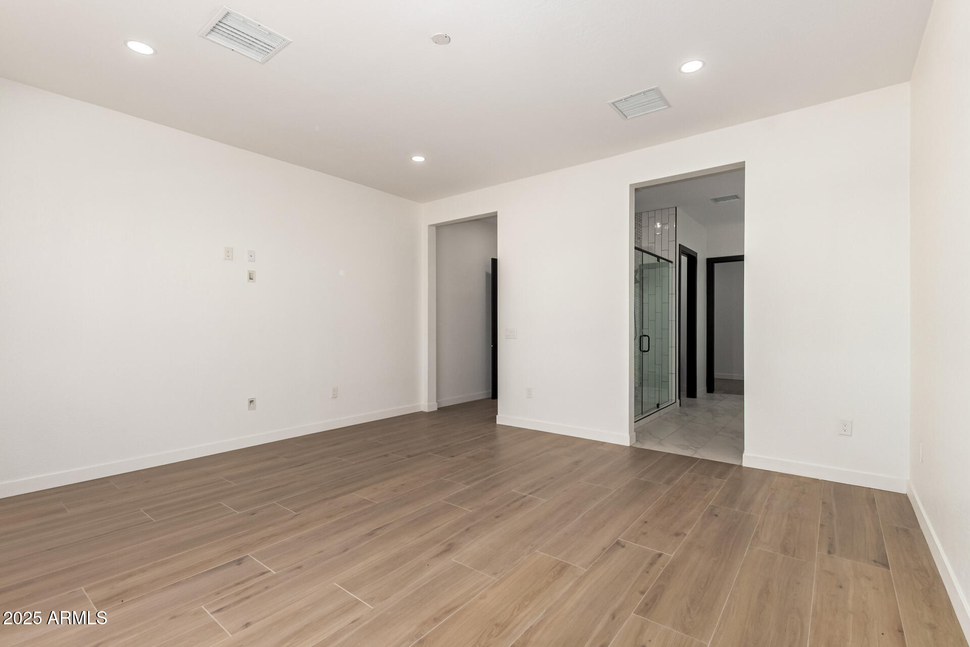 25117 West McArthur Road Wittmann, AZ 85361 - Photo 20 of 43 an empty room with wooden floor and natural light