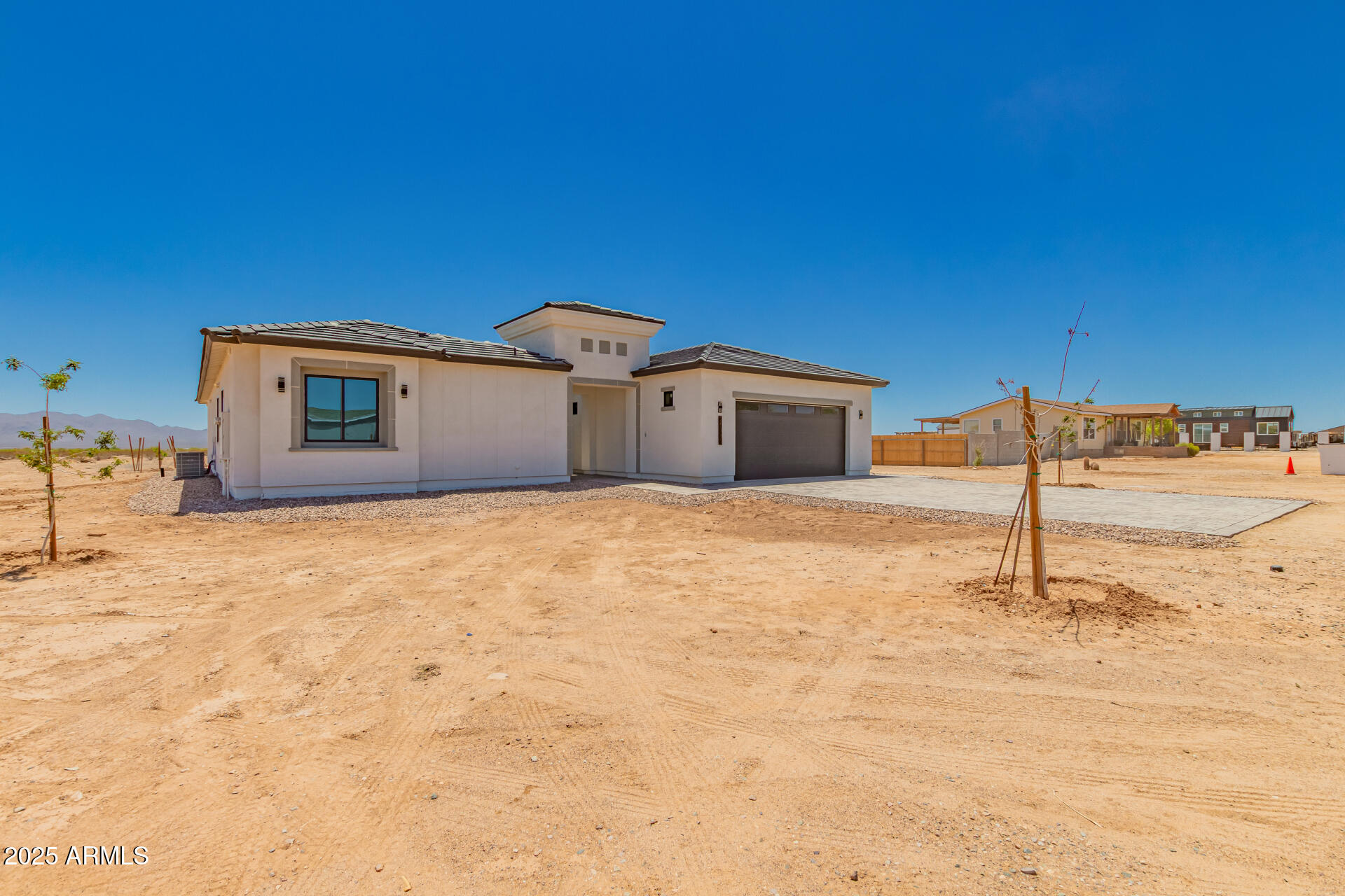 25117 West McArthur Road Wittmann, AZ 85361 - Photo 2 of 43 a house with trees in the background