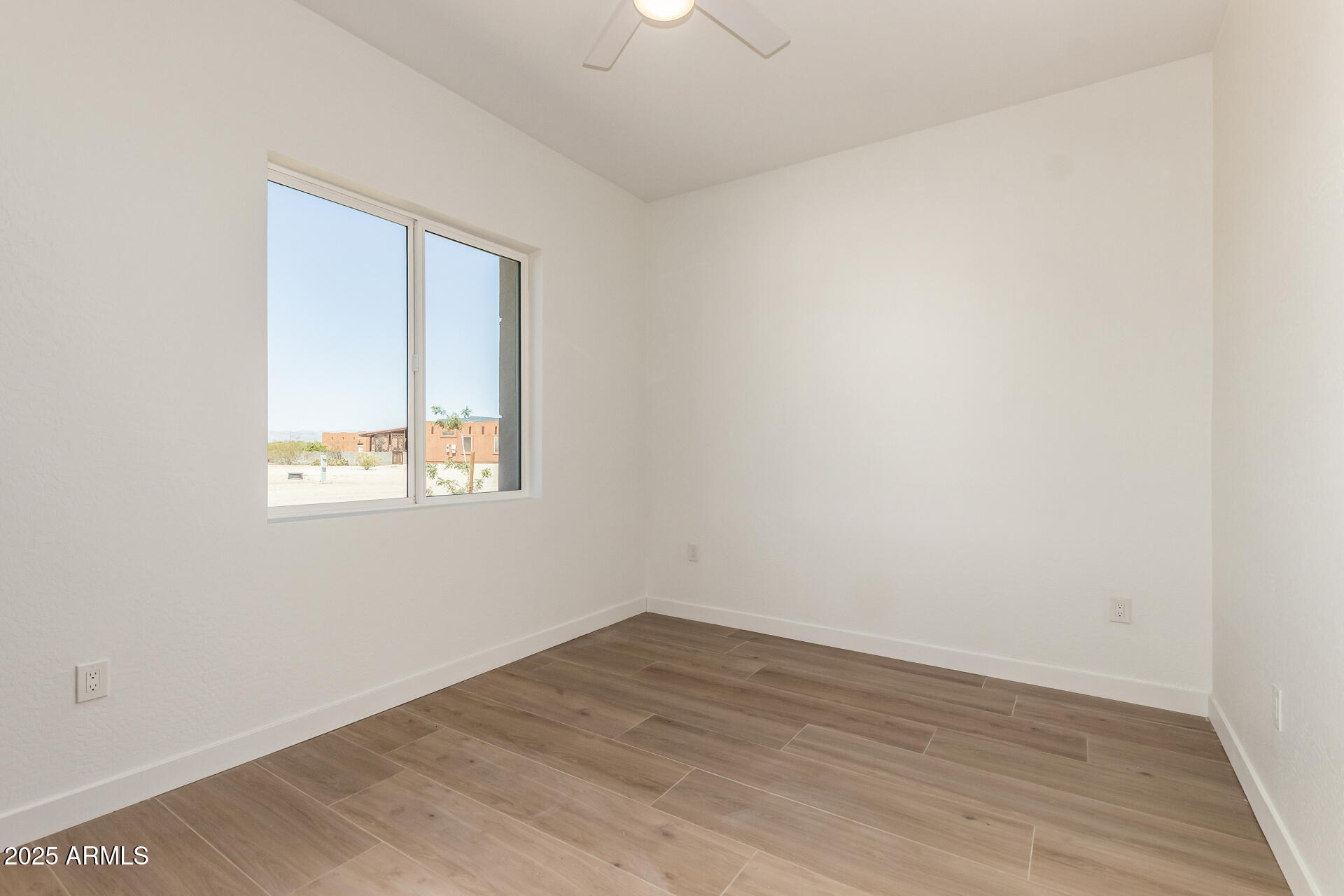 25117 West McArthur Road Wittmann, AZ 85361 - Photo 24 of 43 wooden floor in an empty room