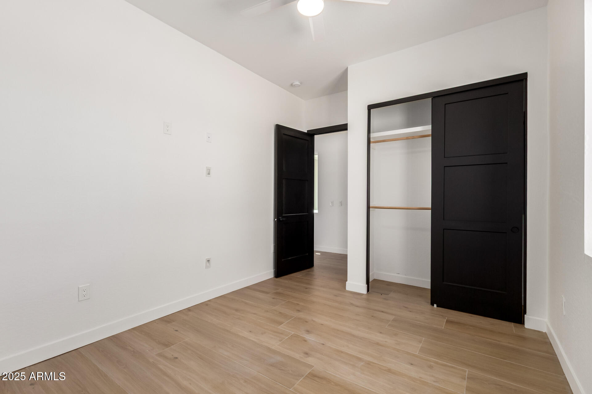 25117 West McArthur Road Wittmann, AZ 85361 - Photo 25 of 43 an empty room with closet and a bathroom