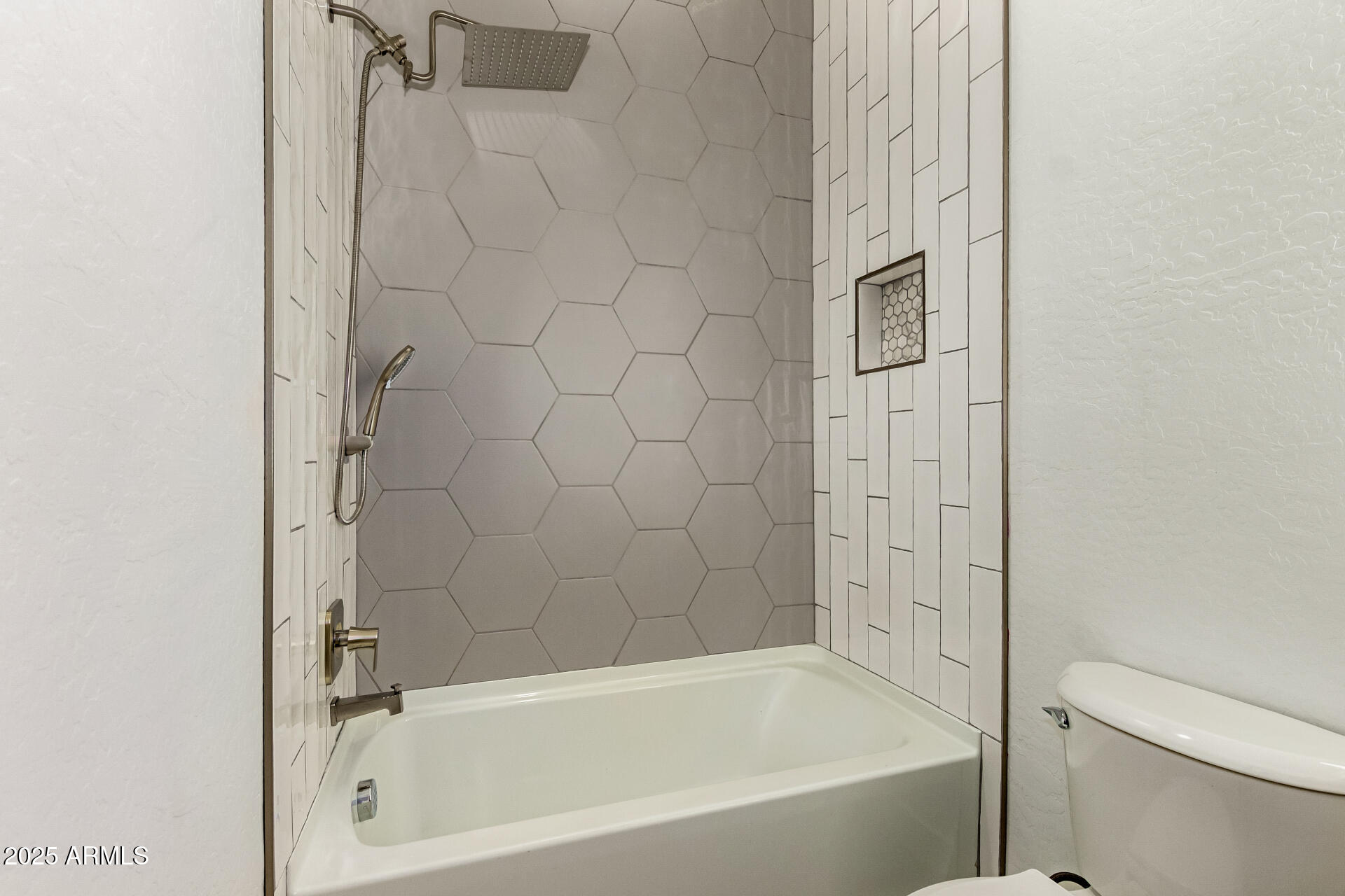 25117 West McArthur Road Wittmann, AZ 85361 - Photo 27 of 43 a bathroom with a bathtub and a shower