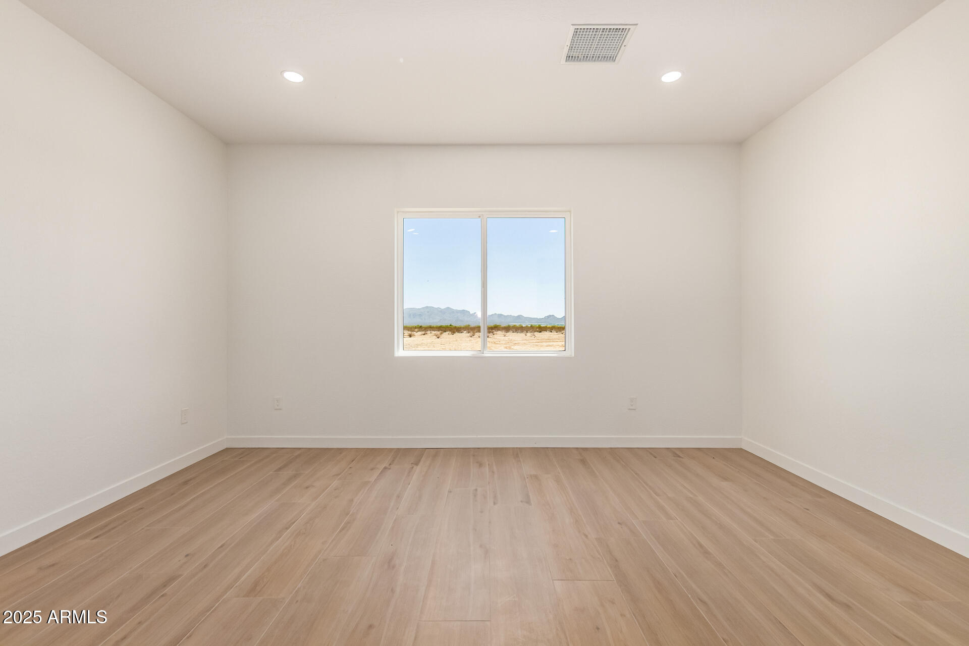 25117 West McArthur Road Wittmann, AZ 85361 - Photo 35 of 43 an empty room with wooden floor and windows