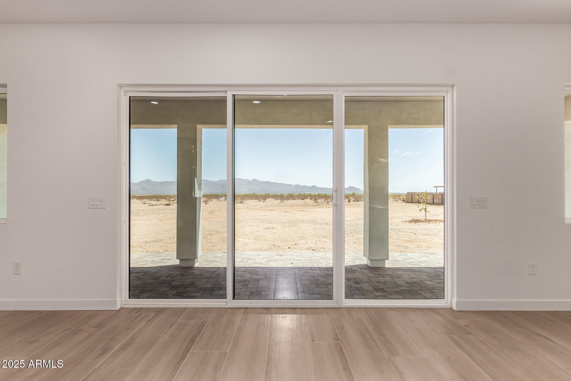 25117 West McArthur Road Wittmann, AZ 85361 - Photo 9 of 43 a view of wooden floor and brick walls