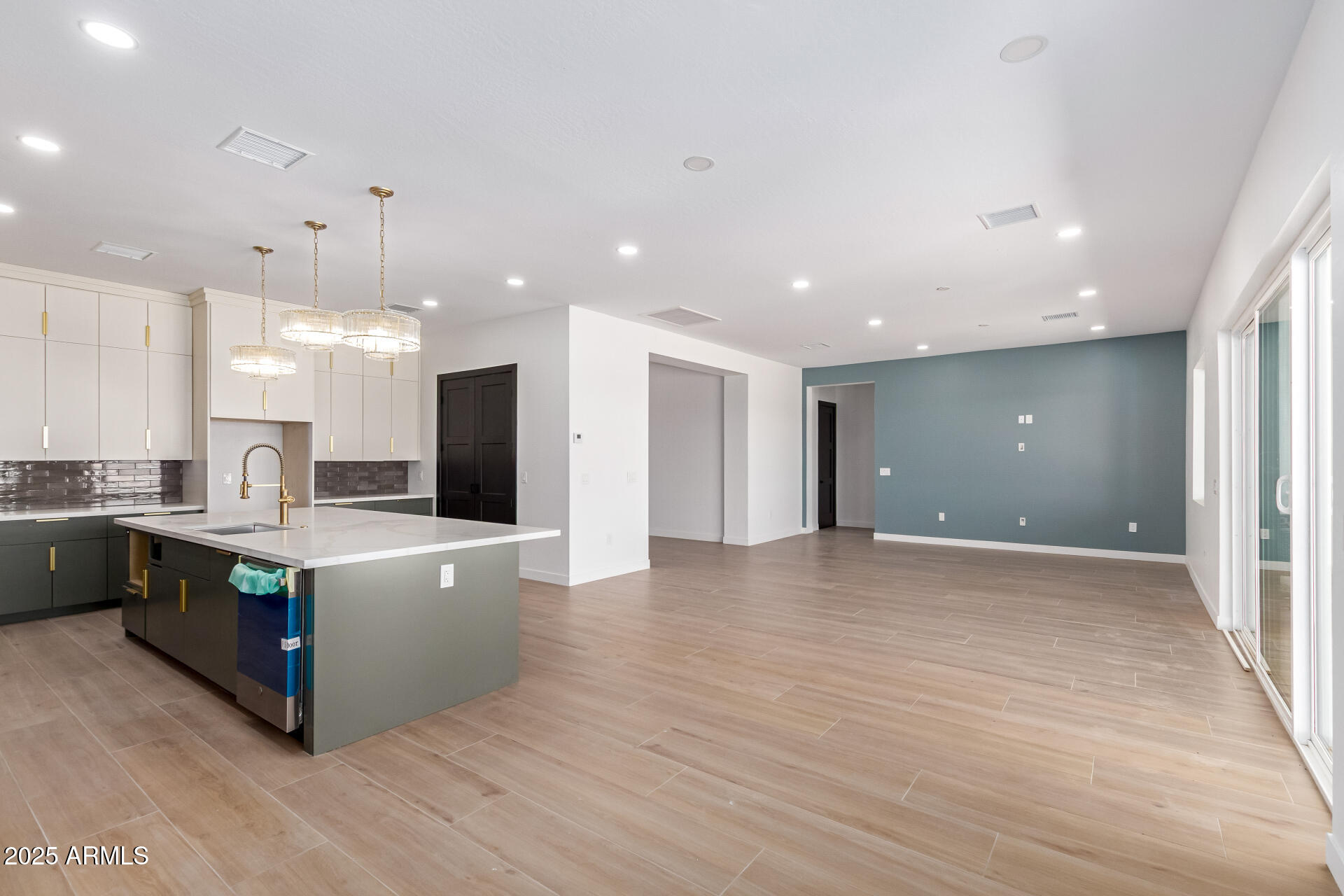 25117 West McArthur Road Wittmann, AZ 85361 - Photo 10 of 43 a view of kitchen with stainless steel appliances granite countertop a refrigerator a sink dishwasher and a oven with wooden floor