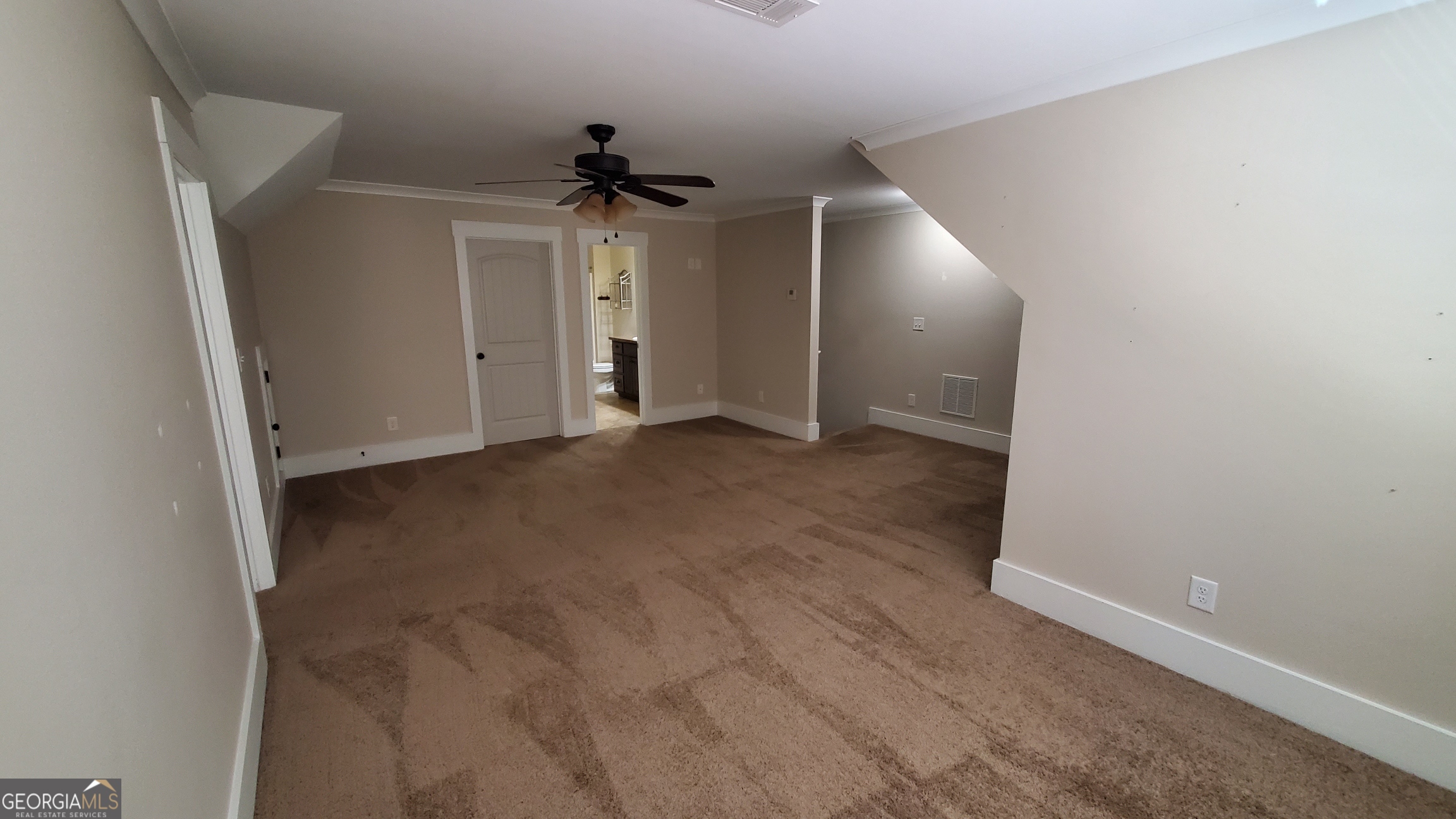 90 Alcovy Reserve Way Covington, GA 30014 - Photo 20 of 28 an empty room with a ceiling fan and closet area
