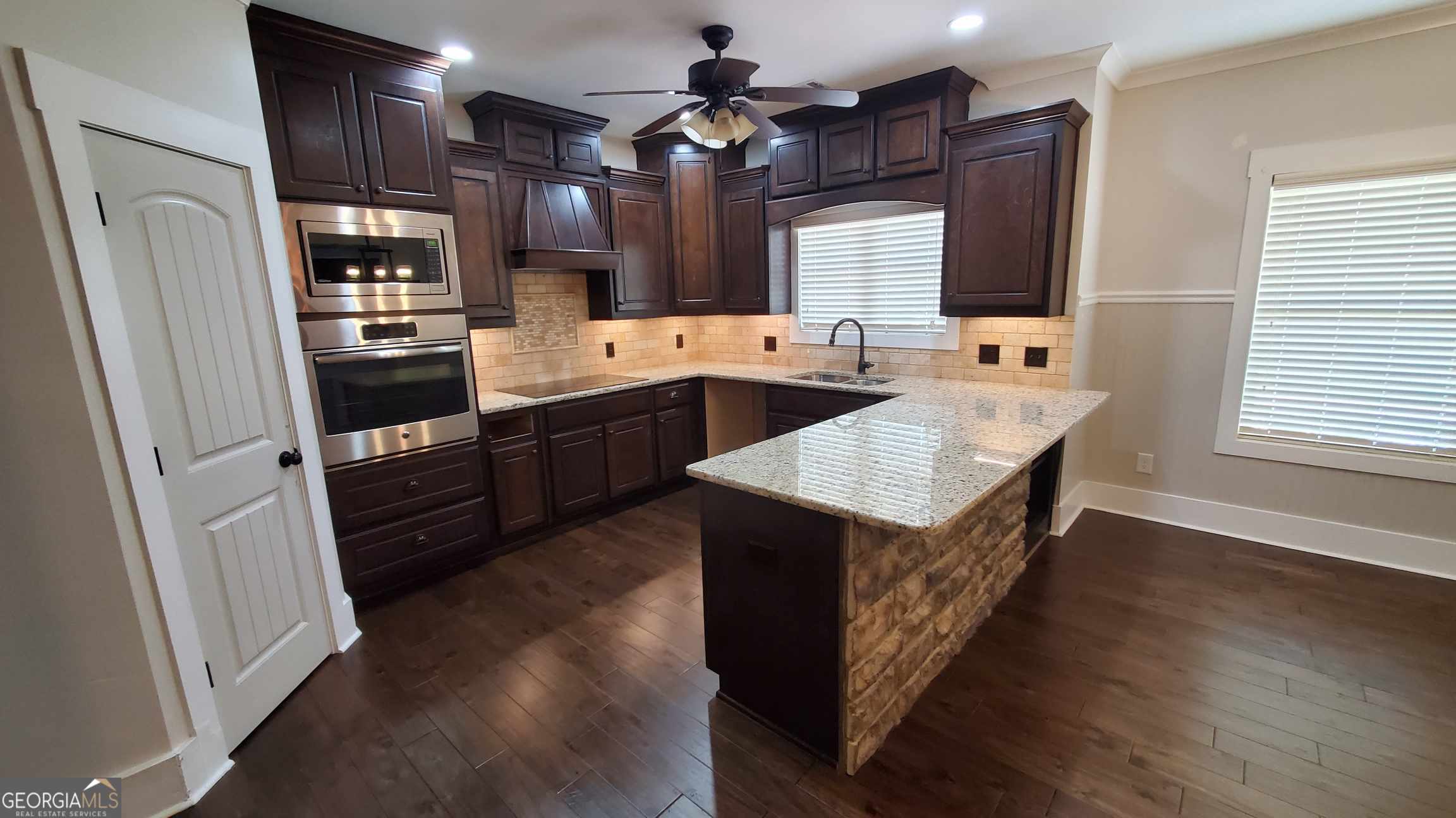 90 Alcovy Reserve Way Covington, GA 30014 - Photo 10 of 28 a kitchen with sink cabinets and wooden floor