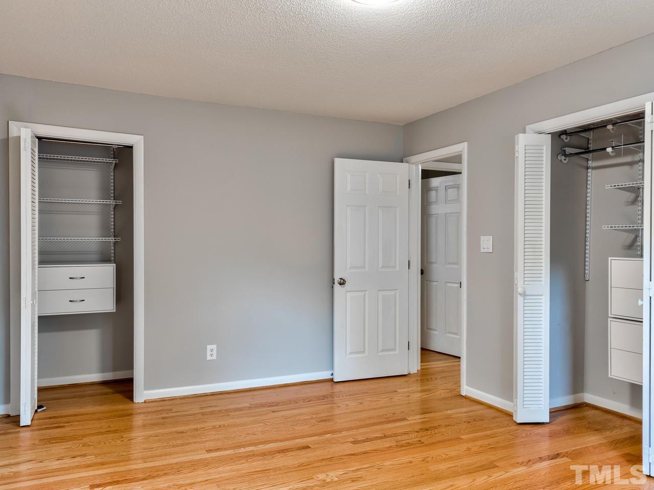 1016 Winona Road Raleigh, NC 27609 - Photo 13 of 25 a view of an empty room and bathroom with wooden floor