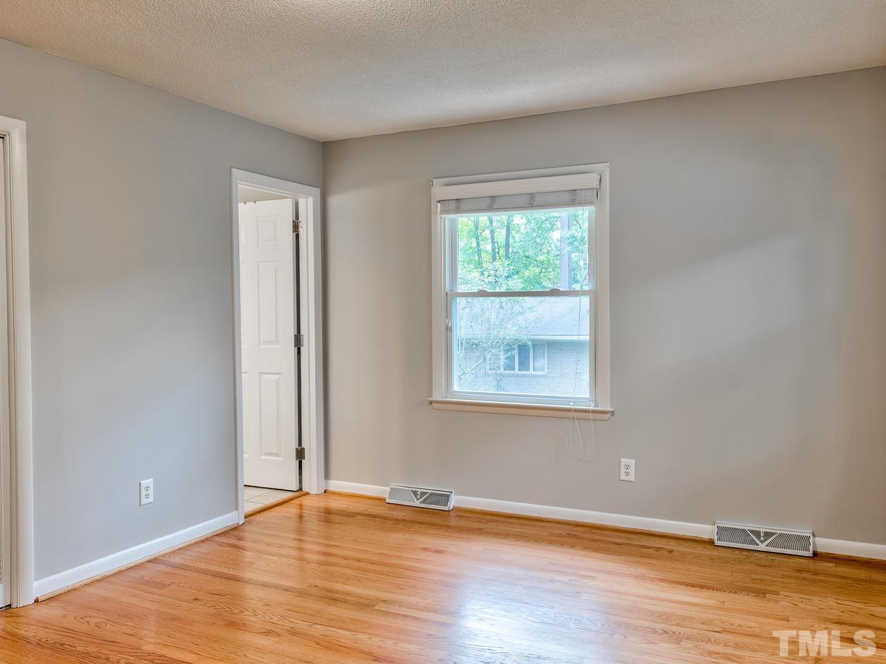 1016 Winona Road Raleigh, NC 27609 - Photo 14 of 25 an empty room with wooden floor and windows