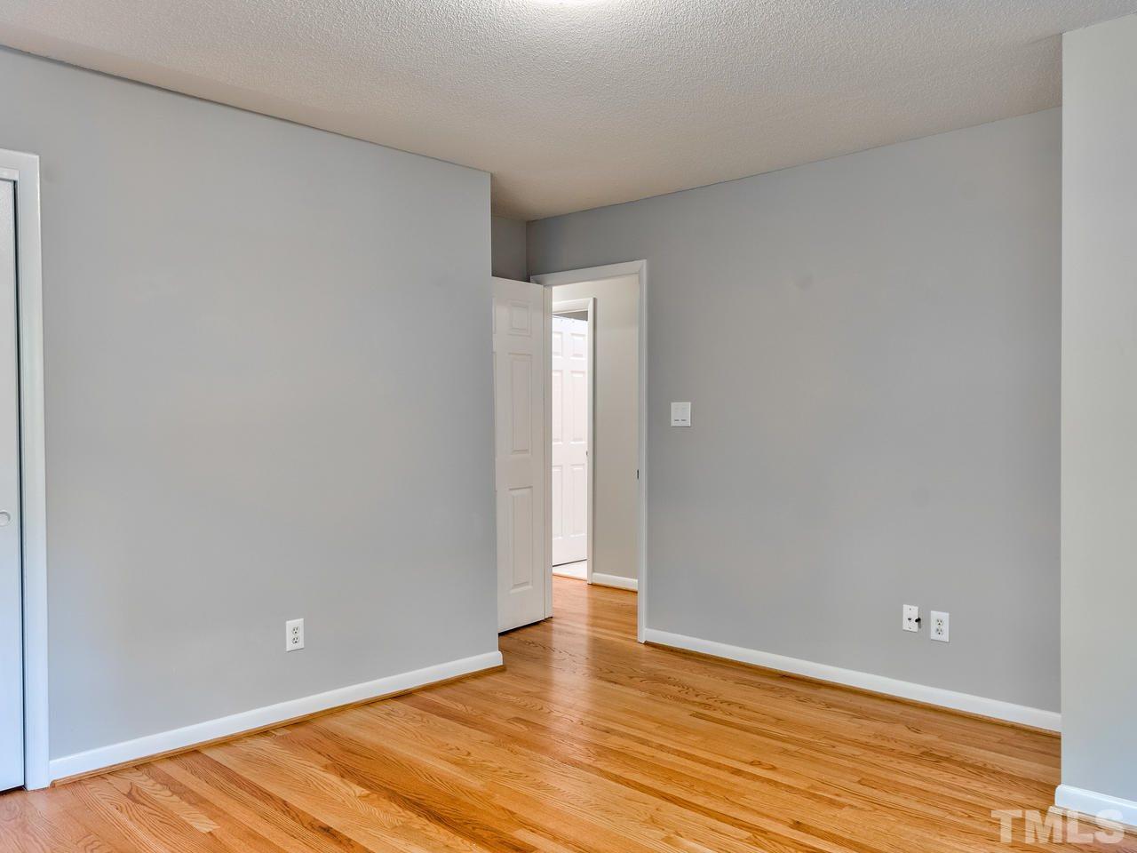 1016 Winona Road Raleigh, NC 27609 - Photo 16 of 25 a view of an empty room with wooden floor and closet