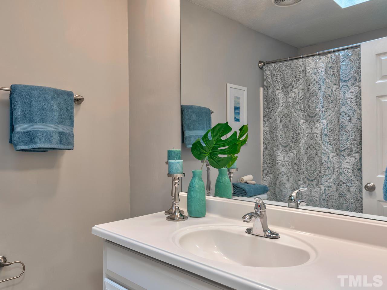 1016 Winona Road Raleigh, NC 27609 - Photo 19 of 25 a bathroom with a sink a toilet and a mirror