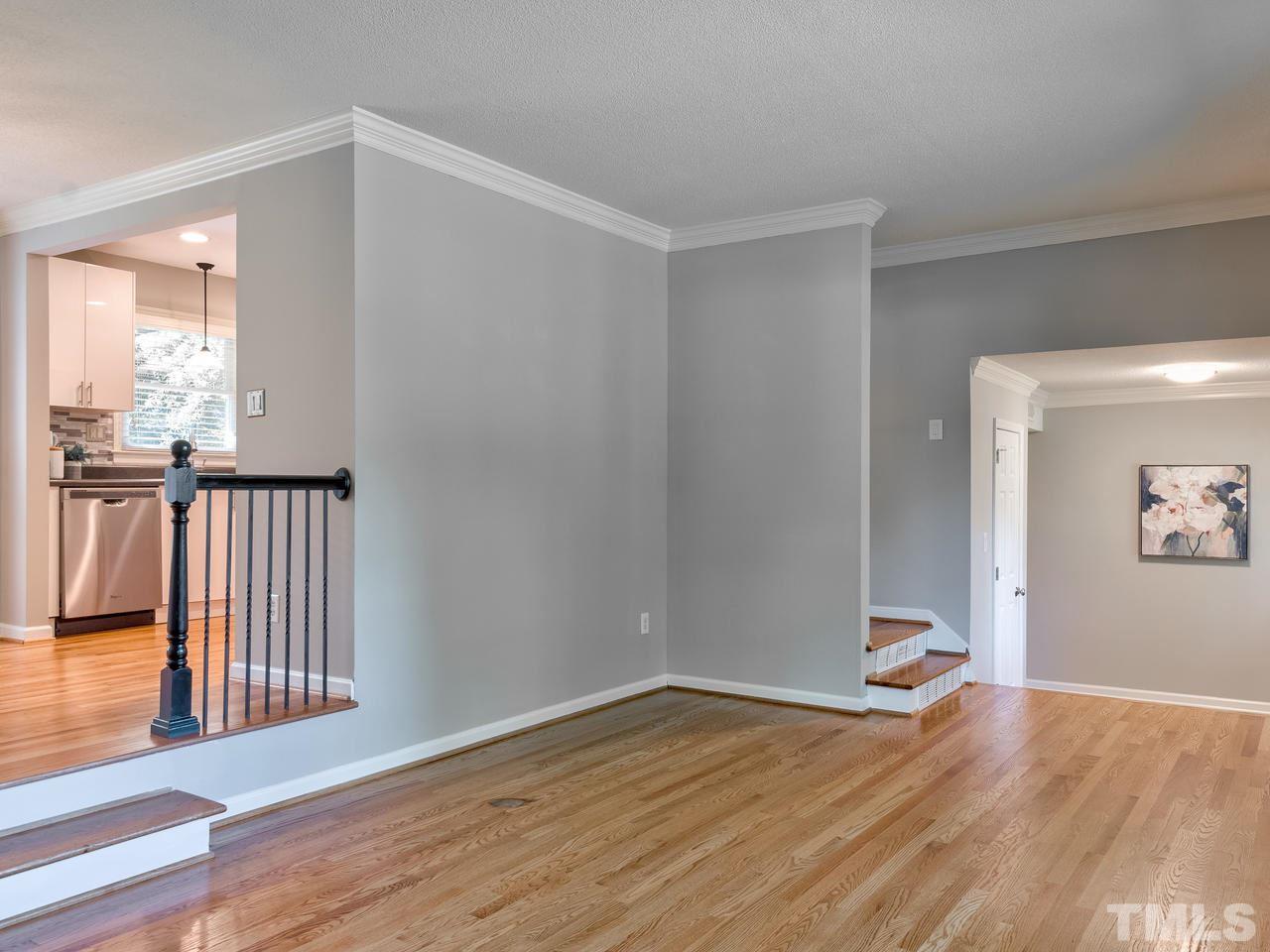 1016 Winona Road Raleigh, NC 27609 - Photo 4 of 25 a view of empty room with wooden floor and fan