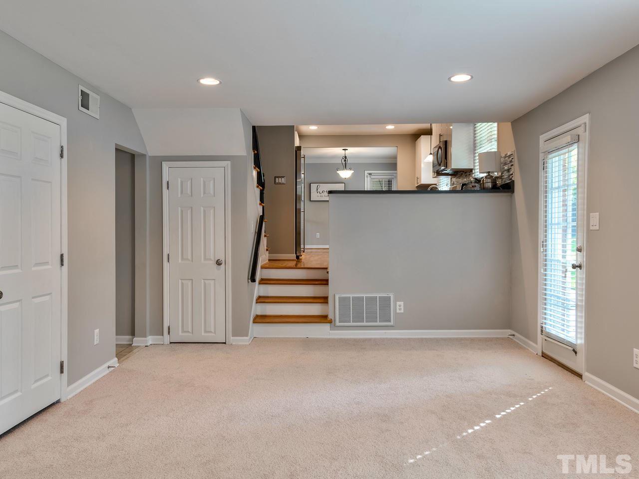 1016 Winona Road Raleigh, NC 27609 - Photo 9 of 25 a view of entryway with kitchen and hall with wooden floor