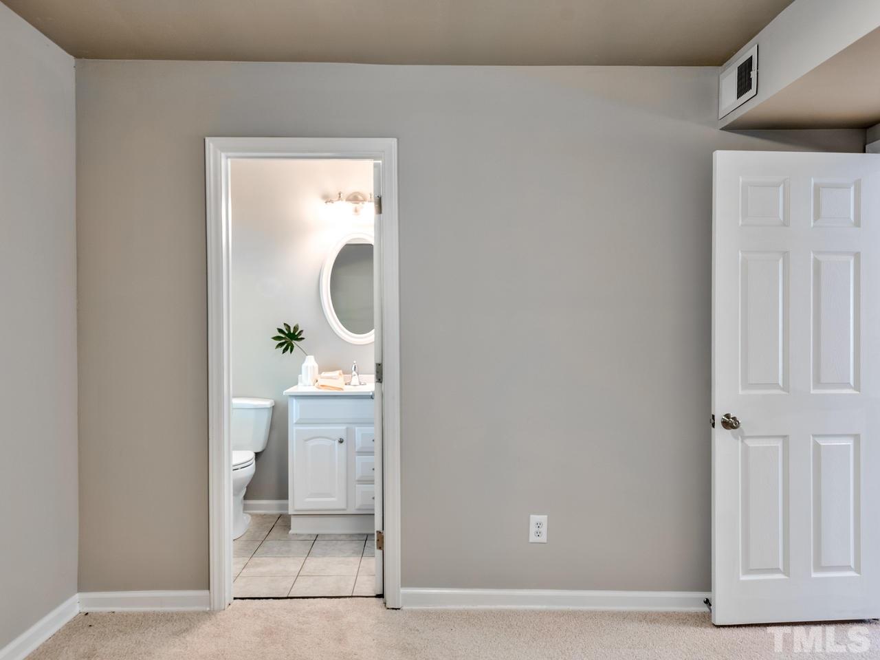 1016 Winona Road Raleigh, NC 27609 - Photo 10 of 25 a en suite bathroom with a granite countertop sink and a mirror