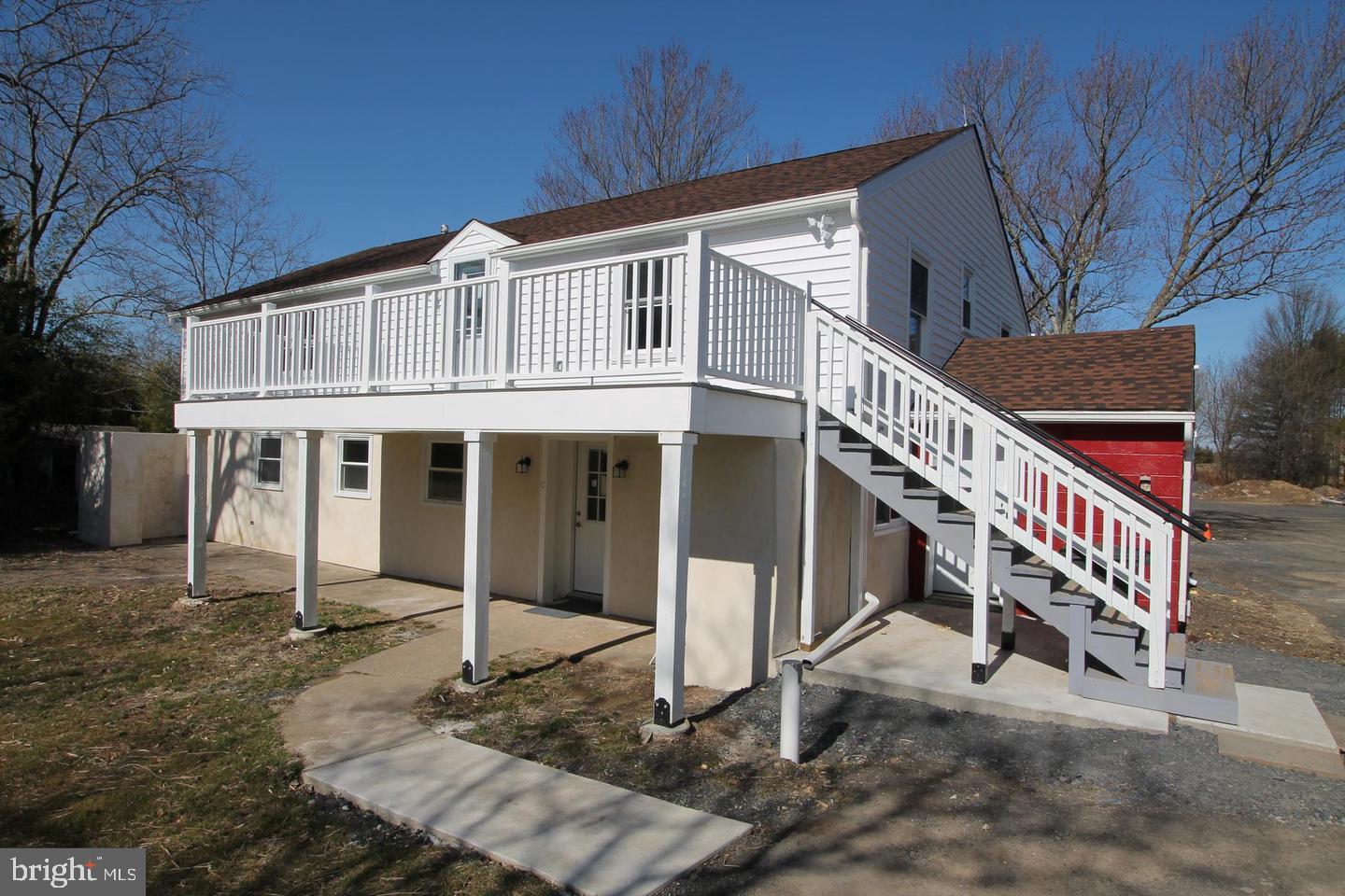 a view of a house with stairs and a yard