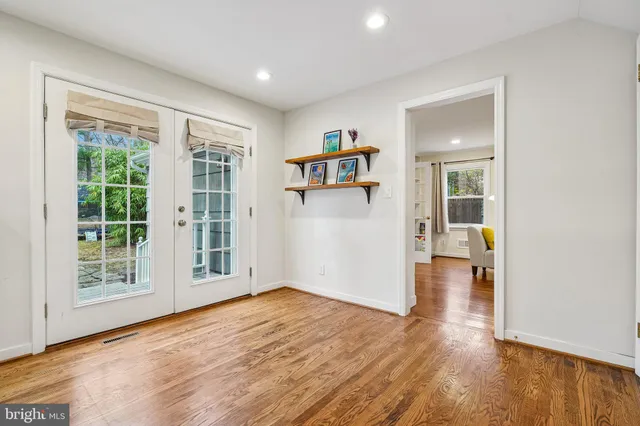 a view of a dining room with furniture and a chandelier