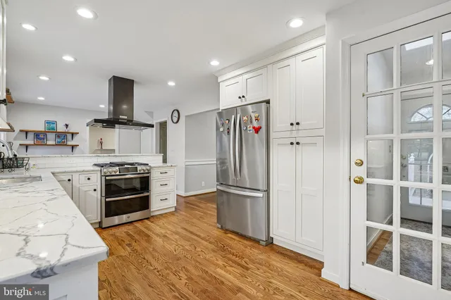 a view of kitchen with wooden floor and electronic appliances