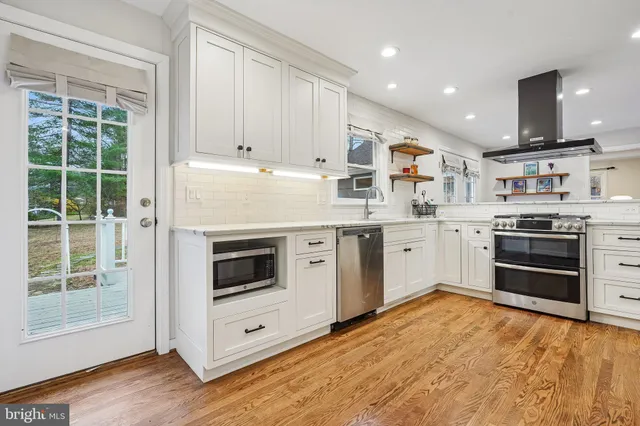 a kitchen with stainless steel appliances granite countertop a refrigerator stove and sink