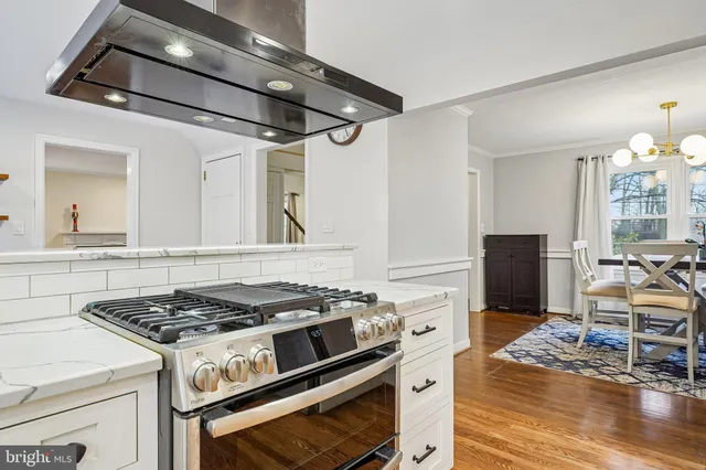a kitchen with stainless steel appliances granite countertop a stove and a refrigerator