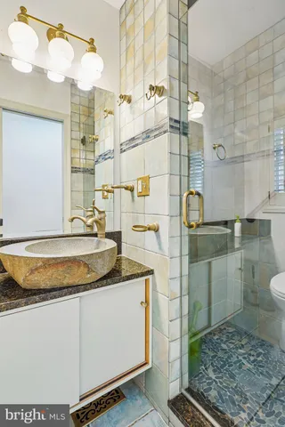 a kitchen with a stove and a wooden floor