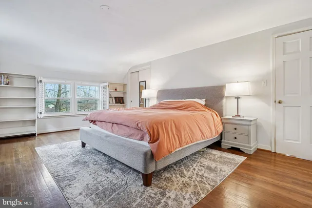 a bedroom with a bed and a night stand