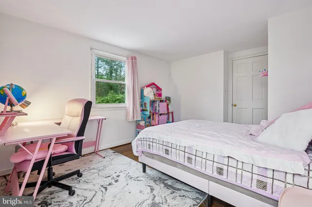 a bedroom with a bed a table and chair