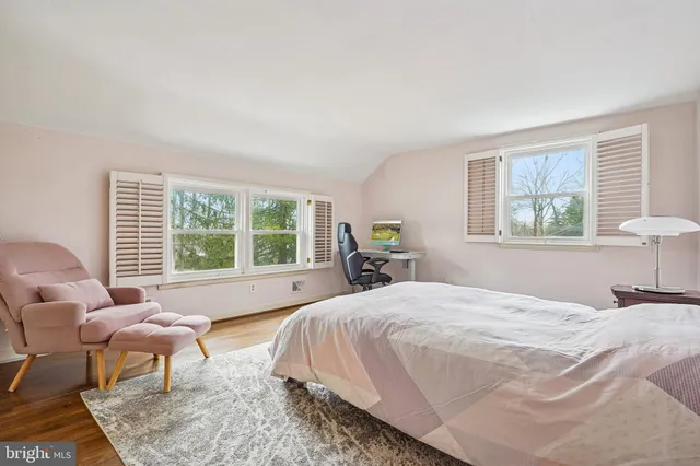 a bedroom with a bed and a couch